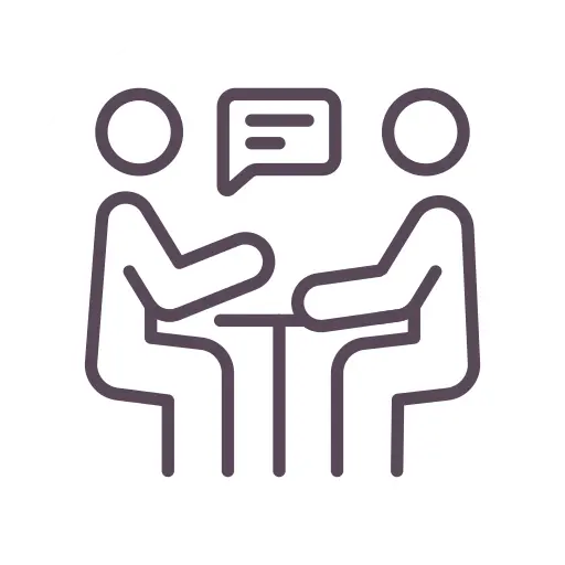 Two stick figures sitting across a table, one with a speech bubble.
